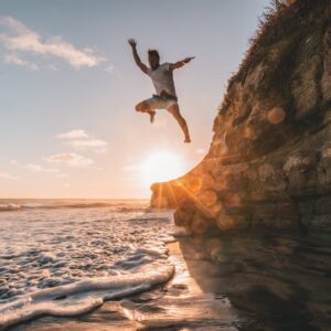Beach Scenery - A man jumps off a cliff at sunset in Encinitas,  #1168742