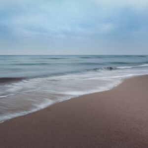 Beach Scenery - Tranquil ocean waves softly crashing on a sandy #12399620