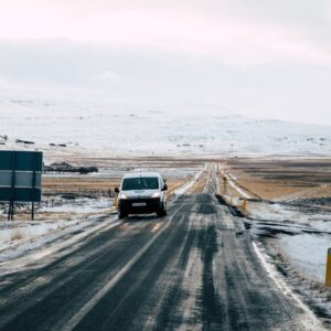 Snow Mountains - A serene winter scene with a road leading throug #17237087