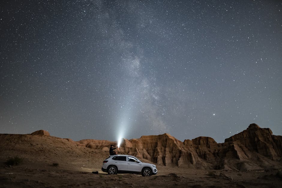 Beach Scenery - A person stands on an SUV under a vast starry ni #3064258