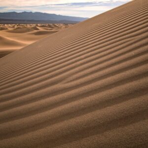 Desert Wilderness - Expansive view of rippled sand dunes under a cle #35962885