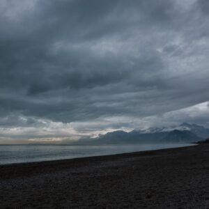 Beach Scenery - A tranquil seascape with dark clouds over a pebb #36179833