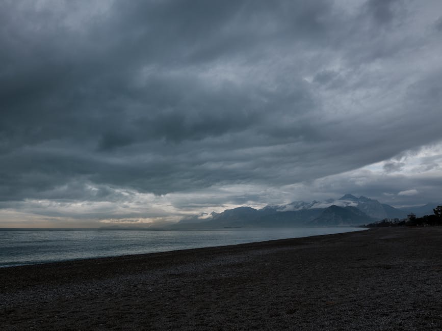 Beach Scenery - A tranquil seascape with dark clouds over a pebb #36179833