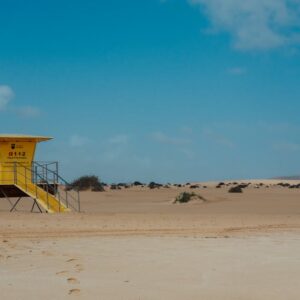 Desert Wilderness - A yellow lifeguard tower stands solitary on the  #36540398