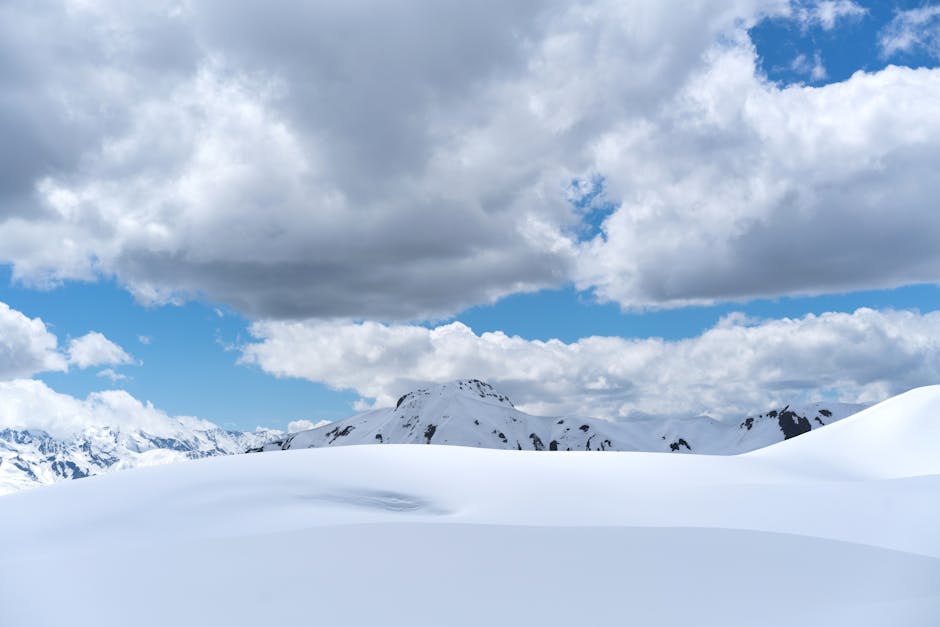 Snow Mountains - Majestic snowy mountains under a cloud-filled sk #4638019
