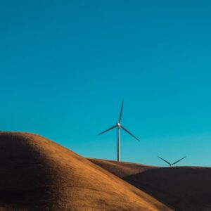 Desert Wilderness - Wind turbines on sandy dunes under a clear blue  #5095830
