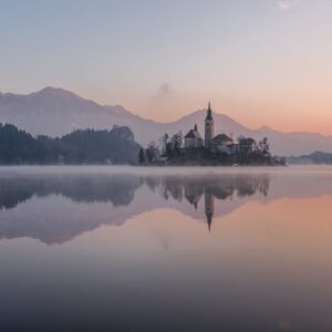 Lake Reflections - Tranquil morning view of Lake Bled with misty re #547125