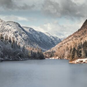 Lake Reflections - Snow-covered mountains and calm lake in Quebec's #7682449